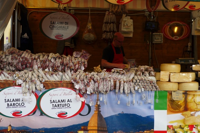 A vendor selling salumi from Piedmont, including salami flavored with Barolo or white truffle, Florence. Credit: Nathan Hoyt